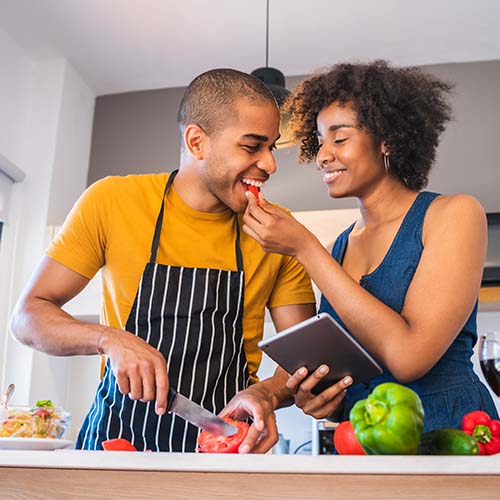 Couple cooking in the kitchen together.