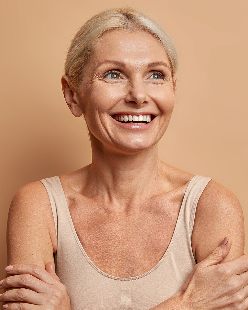 Middle-aged woman with her arms crossed and looking upward