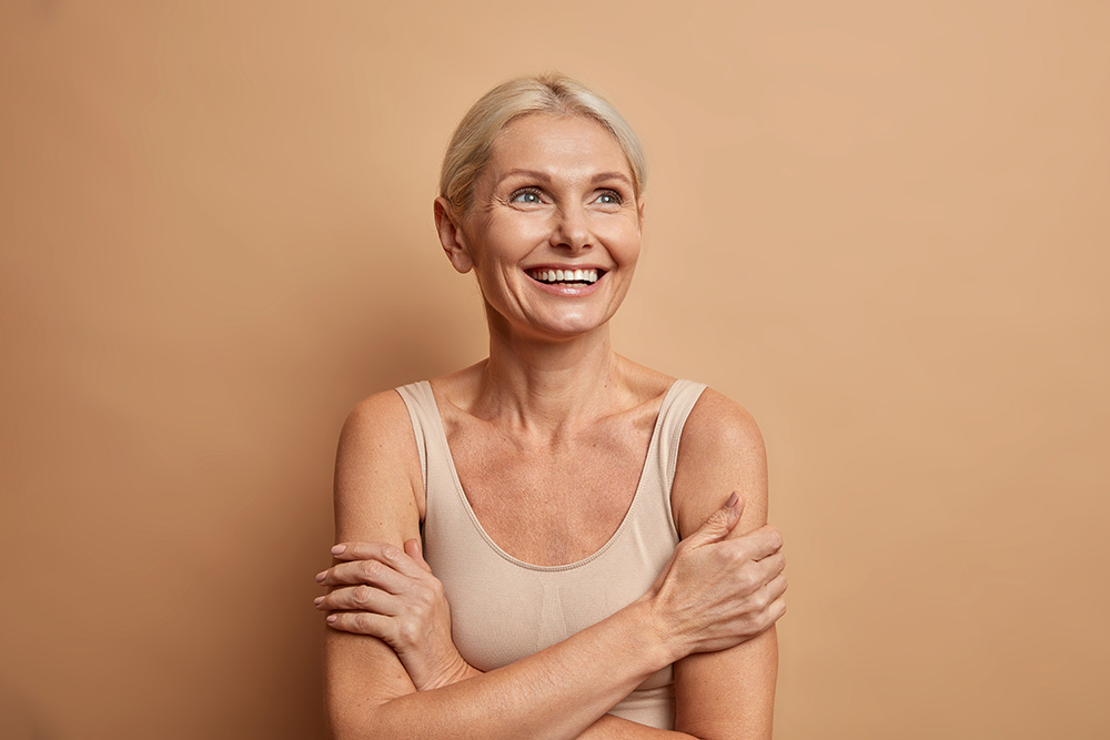Middle-aged woman with her arms crossed and looking upward