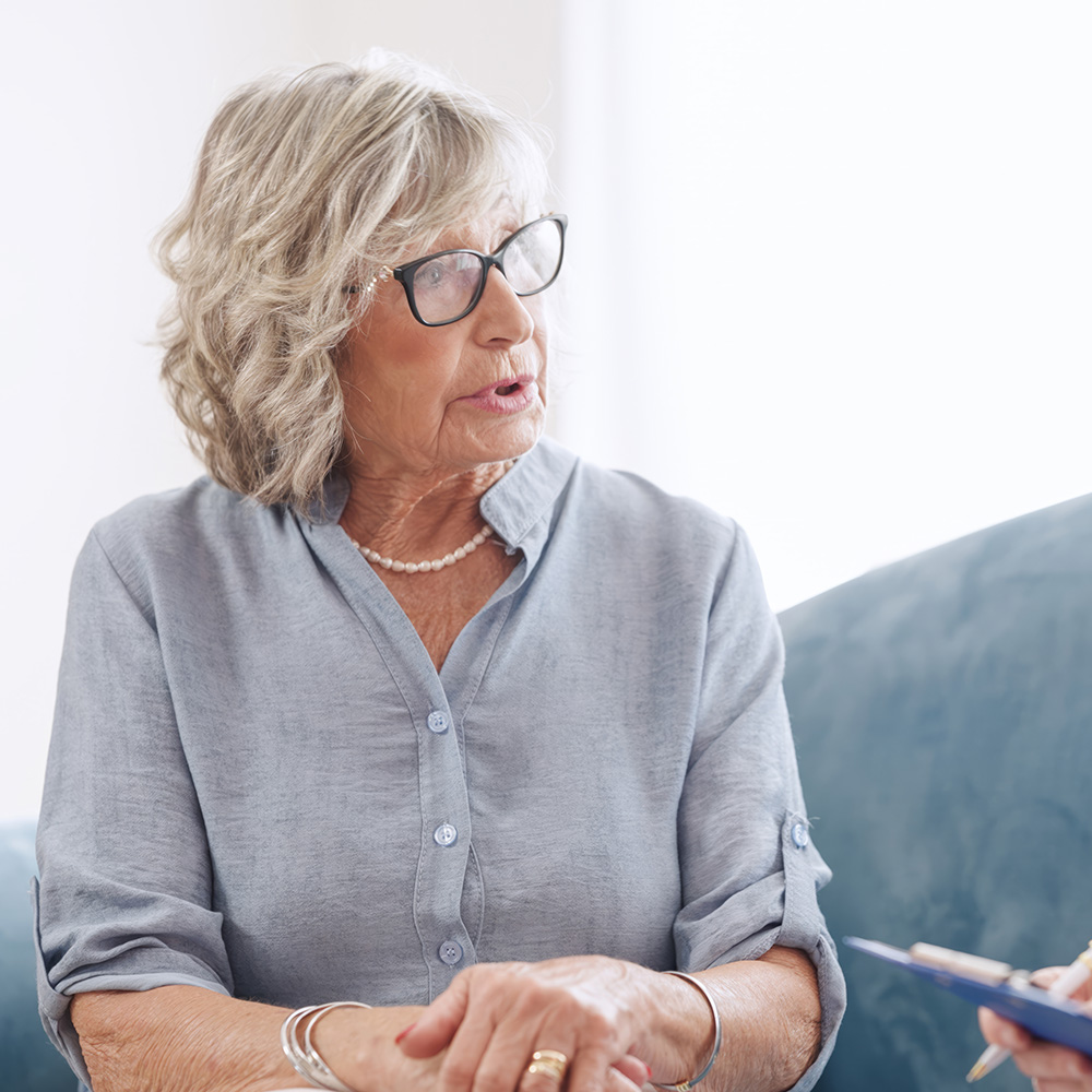 Senior woman sitting on a couch in the clinic