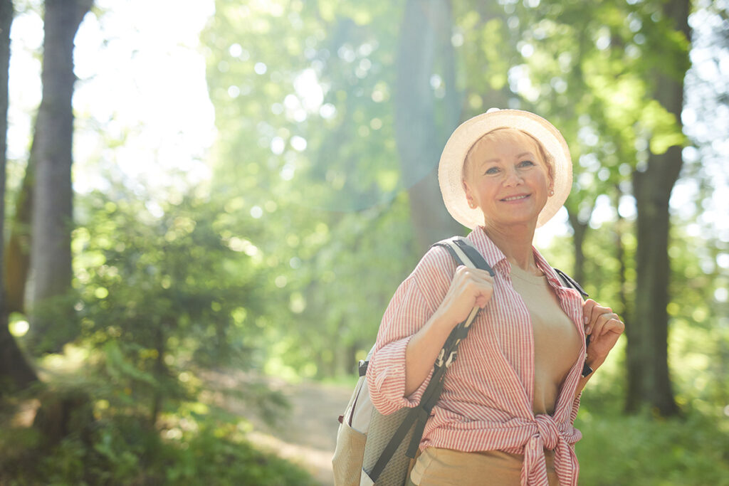 Older woman walking in the forest