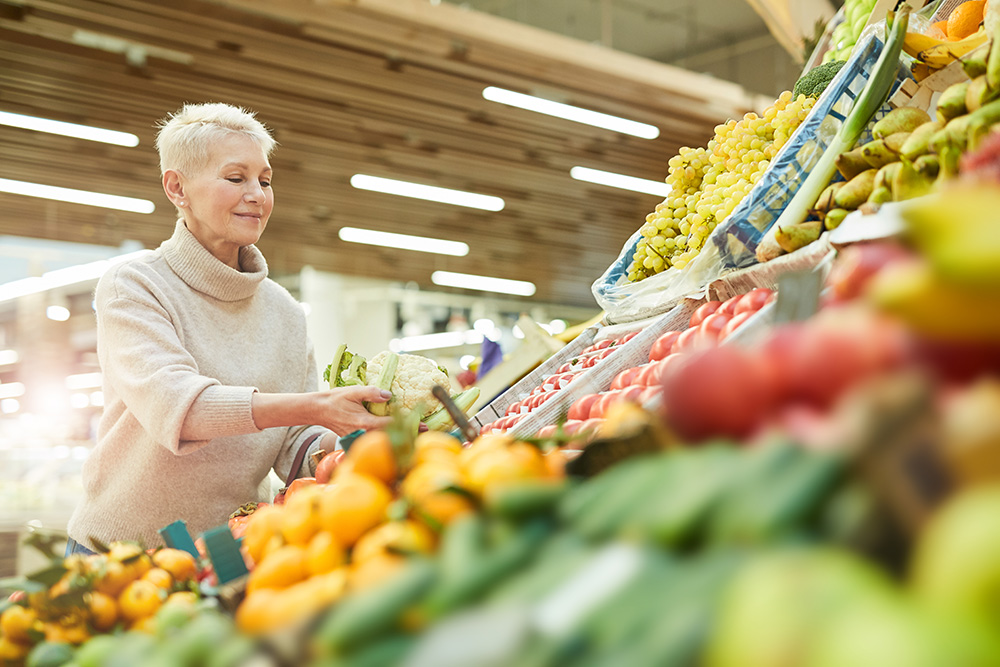 Woman choosing fresh vegetables at the store